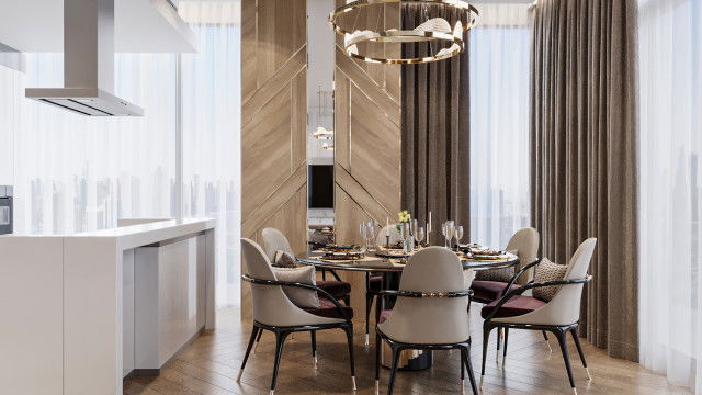 This picture shows a luxurious living room with a rich color scheme and modern furniture. The walls are painted in a bold dark blue and the ceiling is adorned with shimmering gold tiles. The room has a large, beige velvet tufted couch and two matching chairs, a white marble coffee table, and stylish gold-framed wall mirrors on either side of the fireplace. A beautiful crystal chandelier hangs from the ceiling, adding a touch of glamour to the space.