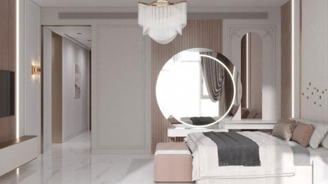 This picture shows a luxurious formal dining room. The room is decorated with a grand chandelier, beautiful artwork, and ornate furniture. An impressive wooden dining table is surrounded by upholstered chairs with tufted details. Two large area rugs provide a plush background to the design of the space, while the walls are covered in an inviting warm-toned paint color.