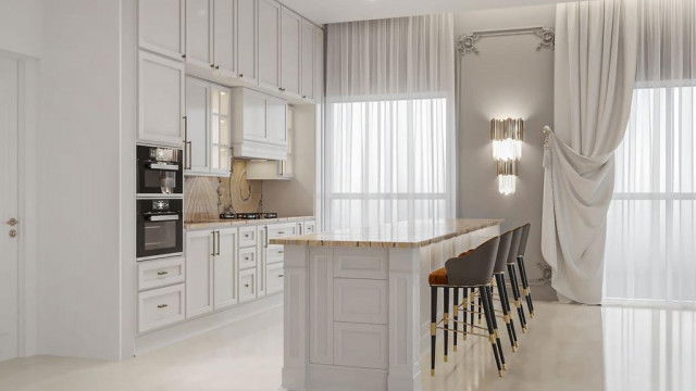 This picture shows a modern, sleekly designed kitchen with white and gray cabinets, a center island, and a white countertop. The cabinets are set against a light gray wall with a wood accent, and the kitchen features appliances such as a built-in refrigerator, convection oven, wine cooler, and range hood. A marble backsplash, stainless steel accents, and recessed lighting complete the look.