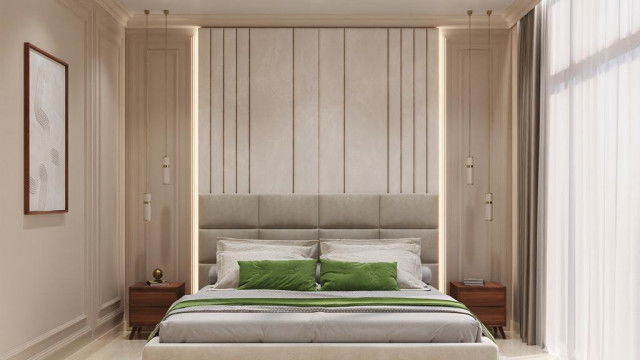 This picture is of a modern, luxury home designed by Antonovich Design. The home features white stucco walls with black and grey accents, surrounded by lush greenery and palm trees. There is a large patio area with a seating area and a swimming pool in the center. The large, glass windows give the house a light and airy feel, while the dark colors create a sophisticated and contemporary atmosphere.