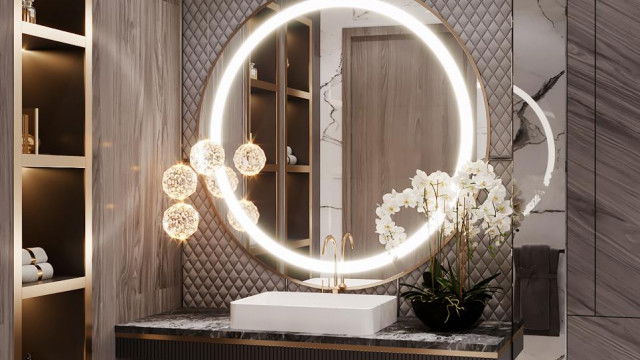 This is an image of a modern, minimalist bathroom with a single sink and a shower room on one side. The space is mostly white, with sleek finishes and minimal decor for a clean, contemporary look. The walls are tiled with a combination of white and grey tiles, which also accent the space. The shower room has a glass partition and sliding door, making the space appear more open. Lastly, there's a large mirror on the wall above the sink.