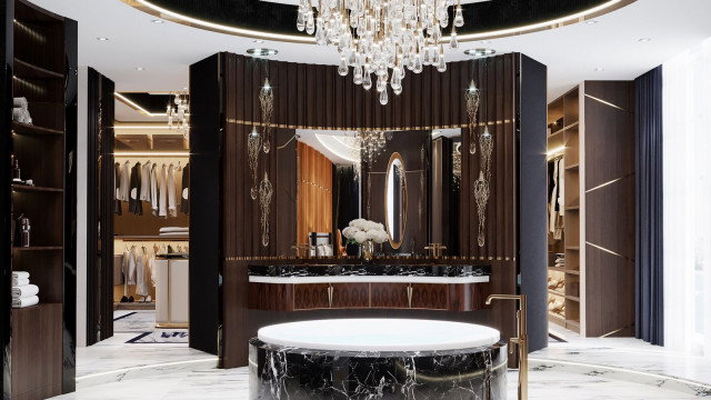 Modern luxury bathroom with decorative ceramic tile walls and a black granite counter top surrounding a double sink, large mirror, and bathtub separated by a glass wall.
