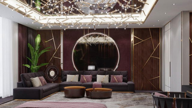 This picture is of an ornate traditional bathroom design with a luxurious gold and white color palette. The walls are decorated with intricate mosaic designs, and the floor is made of large white and gold marble tiles. There is a large freestanding bathtub in the center of the room and several accents of dark wood for furniture. There is also a large window on one wall, letting natural light into the room.