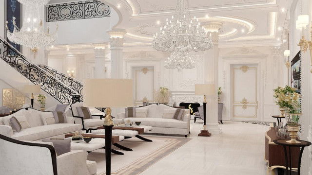 A grand lobby with a ceiling featuring a luxury crystal chandelier, a white marble floor, and grand staircases leading up to the second level.