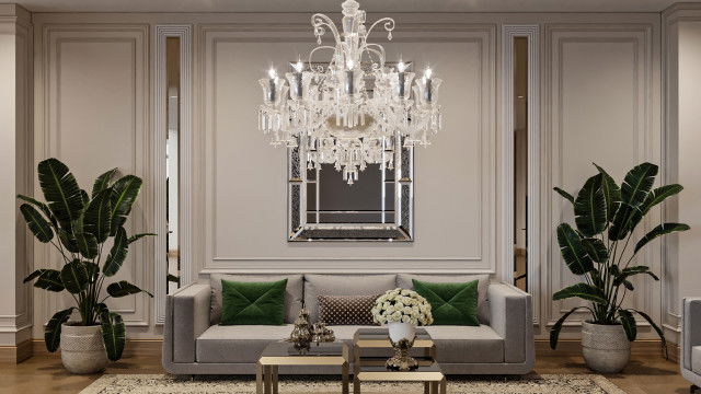 Luxurious contemporary living room with upholstered furniture, an accent wall, and a chandelier.