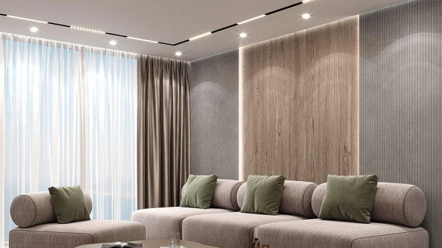 This image shows an ornate and luxurious living room. It has a white marble floor, intricate wood paneling, and beautifully upholstered furnishings. An extravagant crystal chandelier hangs from the ceiling.