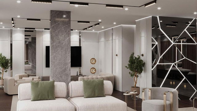 Modern living room with neutral color scheme featuring textured sofa, accent chair, glass-top coffee table and large abstract artwork.