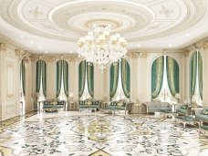 The picture is a black and white aerial photograph of an urban landscape. It appears to show a large city with many roads, buildings, and other structures. The city is surrounded by bodies of water and hills in the distance.