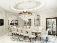 This picture appears to show a large clock tower in the middle of a city, surrounded by tall buildings. The tower is decorated with intricate stone carvings and has several clock faces at different levels. The clock tower stands tall against the sky, presumably used to tell time for the people of the city.