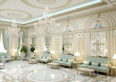 The picture is of a brown and white spotted donkey wearing a saddle and standing in a grassy field with a herd of other donkeys.