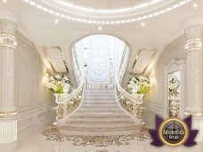 The picture shows a person standing in a grassy field, surrounded by trees and a body of water. The person is wearing a yellow coat and carrying a large red and white sign that reads "HELP!" They appear to be in distress, presumably looking for help.