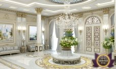 The picture is showing a winding mountain road surrounded by lush green trees. The road appears to be in the mountains, and there are no cars or other people visible. The sky is a light blue with some clouds, adding to the peaceful nature of the scene.