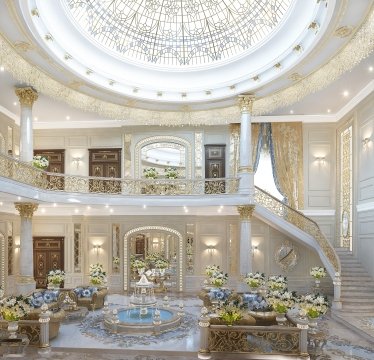 This picture is of a group of people at a Christmas celebration. They are all dressed up in festive party attire and gathered around a Christmas tree, decorated with colorful ornaments and lights. There are two tables filled with food and drinks in the background. The celebrants are smiling and laughing while they take a moment to enjoy the Christmas spirit.