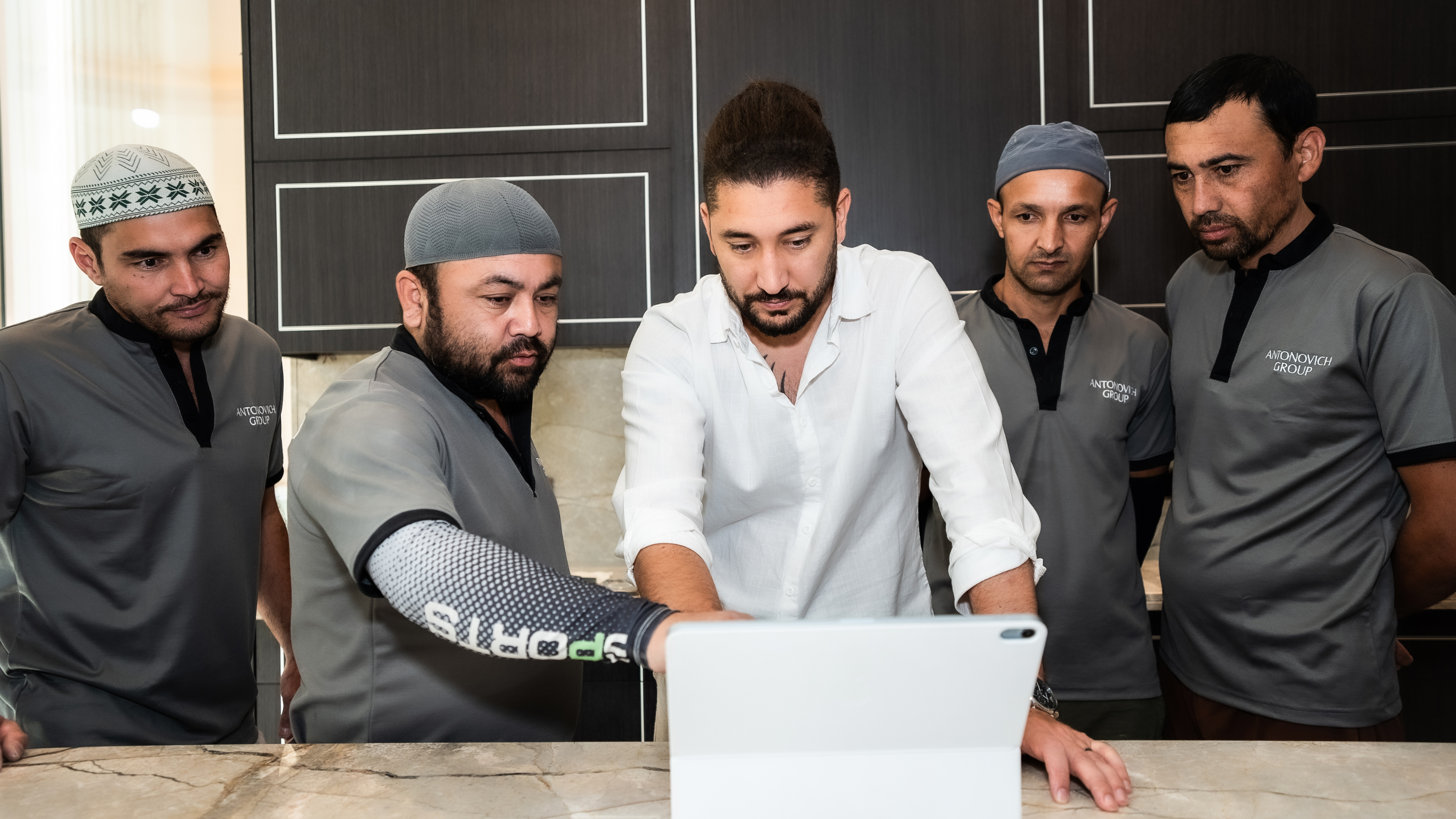 Design team reviewing a kitchen project on a laptop