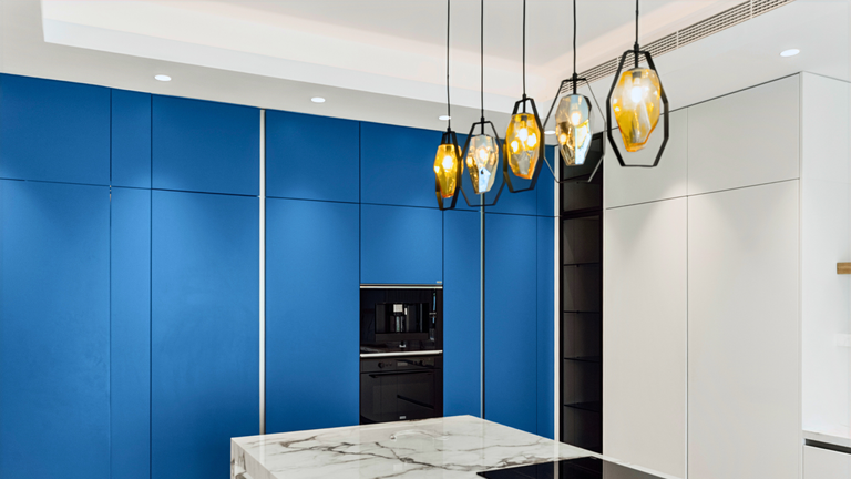Blue cabinetry and marble island